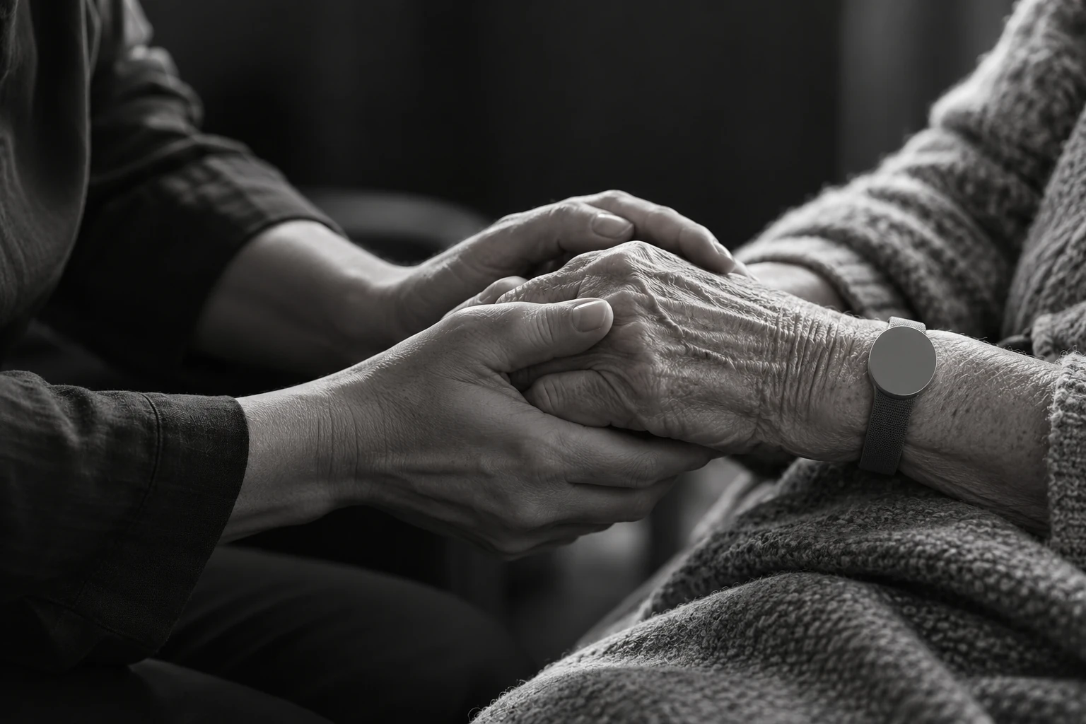 Conceptual photograph of a clinician gently holding a patient’s hand.